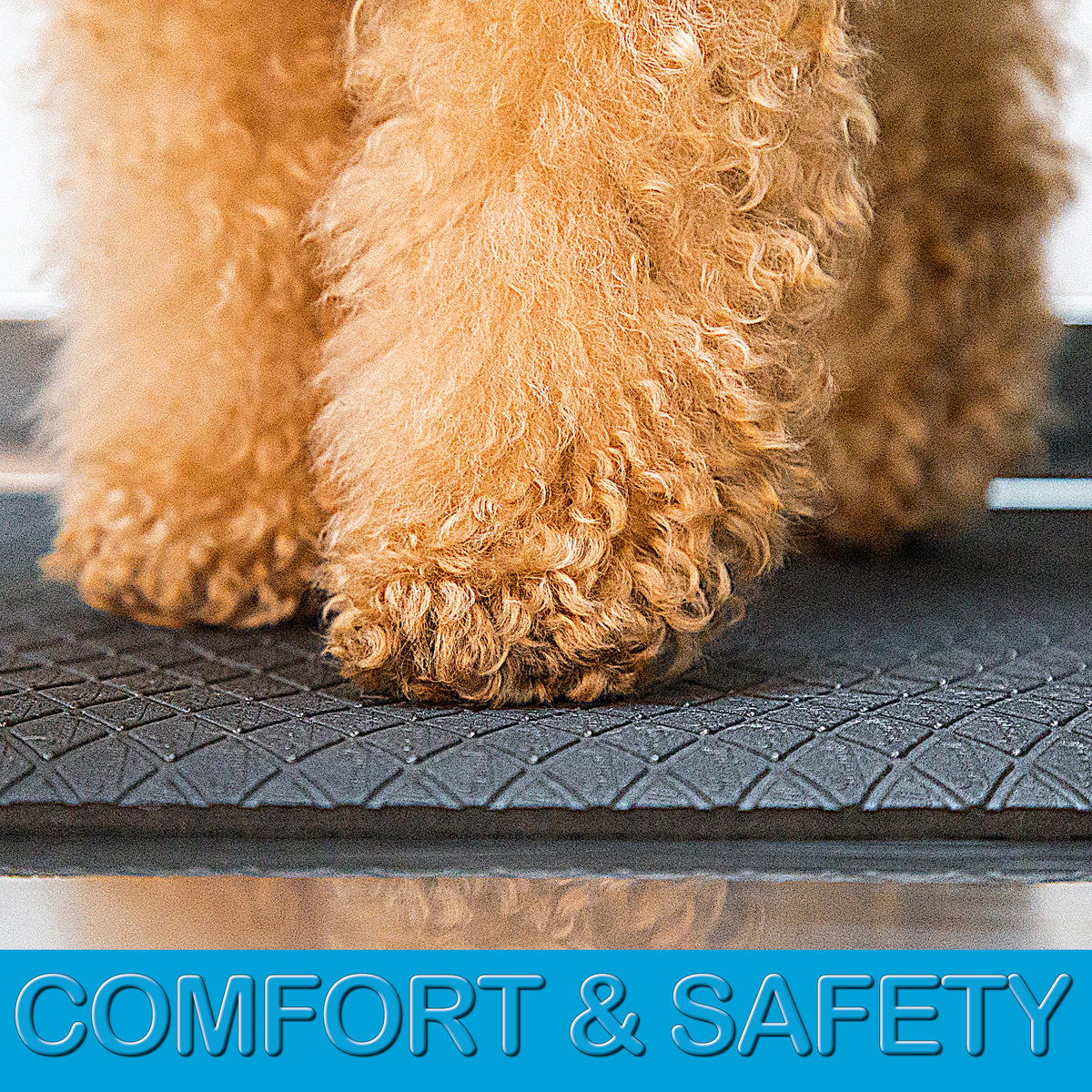 Soft cushioned anthracite grooming mat with non-slip textured backing on a stainless steel grooming table