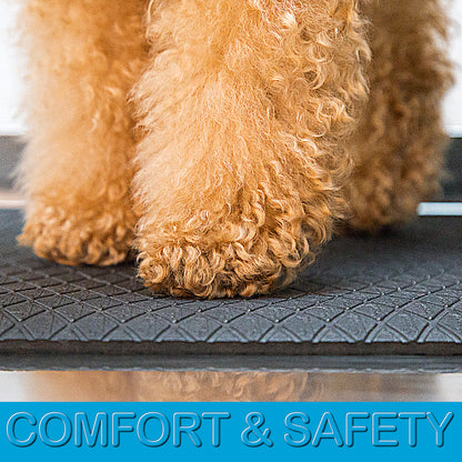Soft cushioned anthracite grooming mat with non-slip textured backing on a stainless steel grooming table