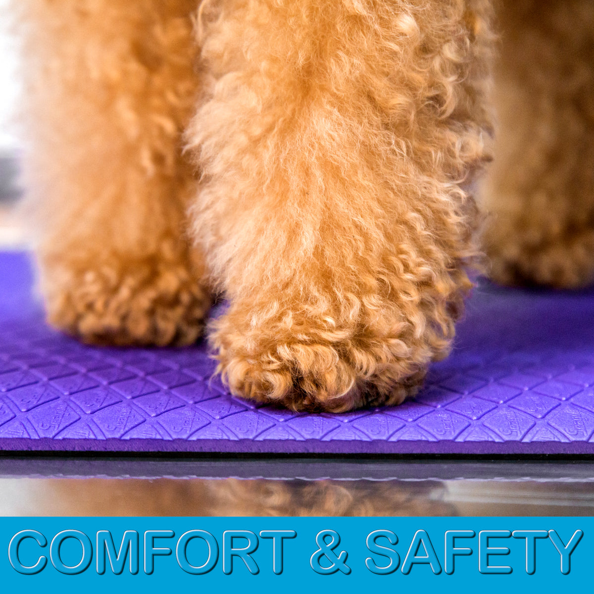 Soft cushioned purple grooming mat with non-slip textured backing on a stainless steel grooming table