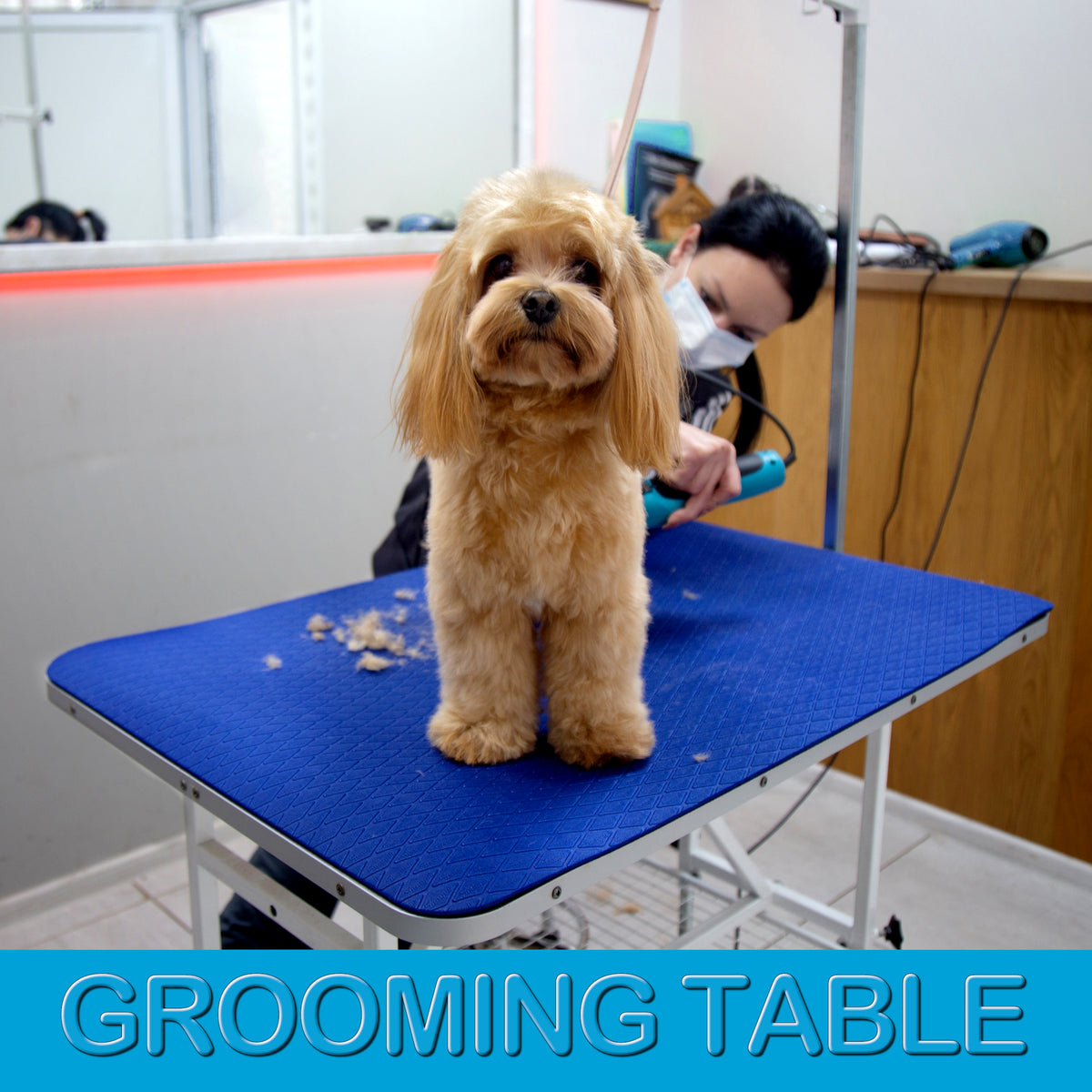 Large 24 × 36 inch dark blue grooming mat covering a professional grooming table