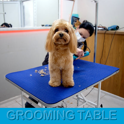 Large 24 × 36 inch dark blue grooming mat covering a professional grooming table