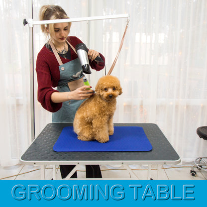 Small 16 × 24 inch dark blue grooming mat on a professional grooming table