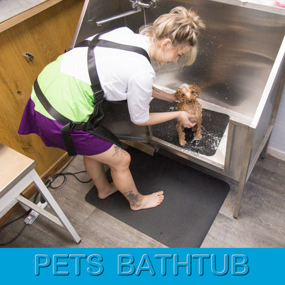 Anthracite non-slip grooming mats used in a pet bathtub and under a groomer’s feet for safer, more comfortable grooming