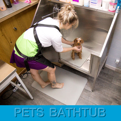 Light grey non-slip grooming mats used in a pet bathtub and under a groomer’s feet for safer, more comfortable grooming