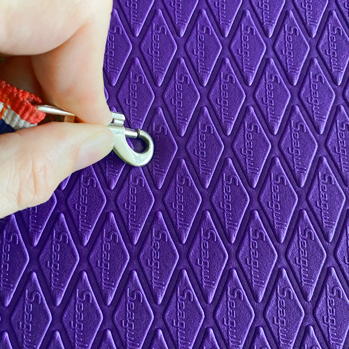 Close-up of soft cushioned purple Seagull dog grooming mat showing flexible EVA surface for paw comfort