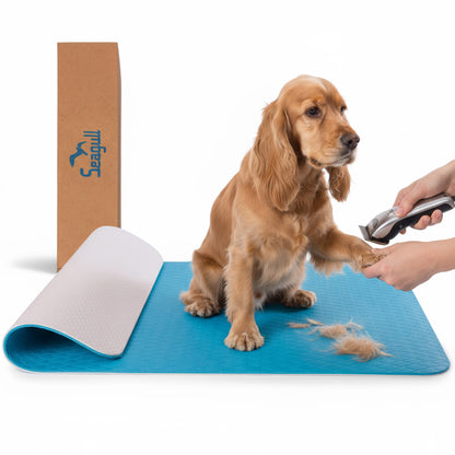 Light blue non-slip dog grooming table mat with dog and grooming clippers
